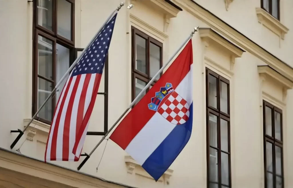 American and Croatian flags hanging outside an official building in Croatia